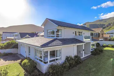 a white house with a lot of windows at Somer Sout in Voelklip, Hermanus in Hermanus
