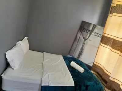 a bed in a small room with two pillows at BDC Paarl Accommodation and Guest House in Paarl
