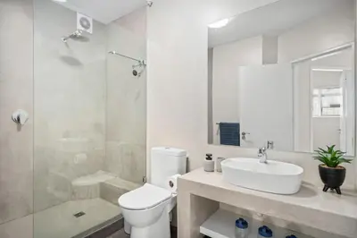 a bathroom with a toilet and a sink and a shower at 14 Cap dAzur by Host Agents in Cape Town