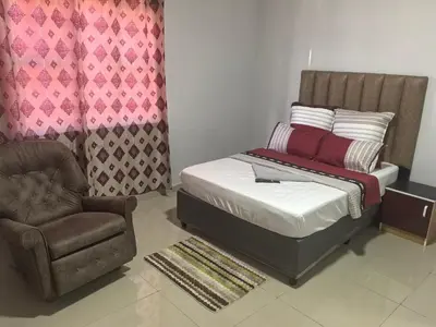 a bedroom with a bed and a chair at Gift Guest house 2 in Cravenby