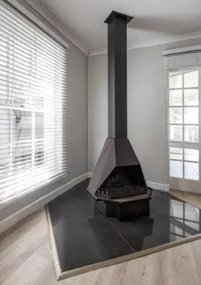 a kitchen with a stove in the corner of a room at Beachcomber's Rest in Hermanus