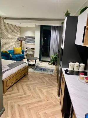 a living room with a bed and a couch at On Park Century City Cozy Apartment in Cape Town