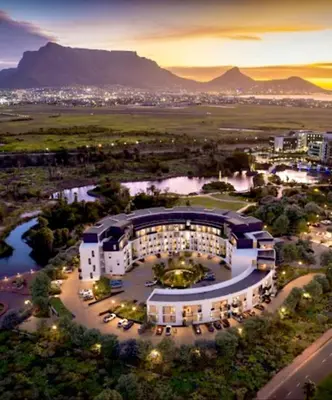 an aerial view of a building with mountains in the background at On Park Century City Cozy Apartment in Cape Town