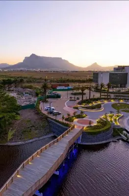 a bridge over a body of water with a road at On Park Century City Cozy Apartment in Cape Town