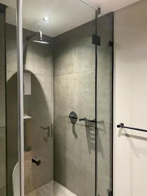 a shower with a glass door in a bathroom at On Park Century City Cozy Apartment in Cape Town
