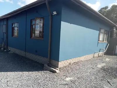 a blue building with a window on the side of it at At-home Oakdale Bellville in Bellville