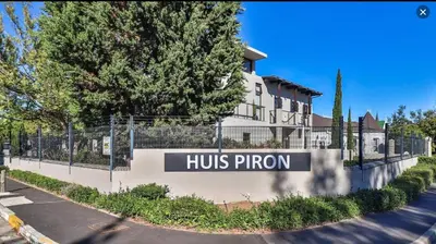 a huts phoenix sign in front of a building at Studio 5 at Huis Piron in Stellenbosch