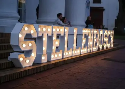 a lit up sign that reads the bushdir at Studio 5 at Huis Piron in Stellenbosch