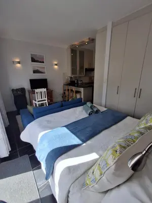 a bedroom with two beds with towels on them at Studio 5 at Huis Piron in Stellenbosch