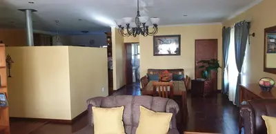 a living room with a couch and a table at Protea-Sabr in Sir Lowry Pass