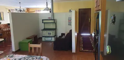 a hallway with a living room with a stove in it at Protea-Sabr in Sir Lowry Pass