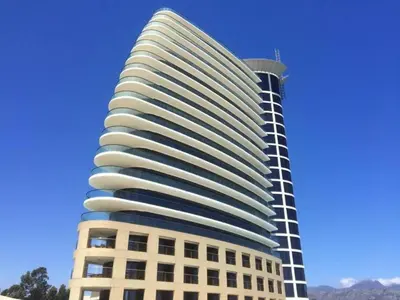 a tall white building with a black at Luxury 3BR - 804 Ocean View Pool & Parking Beach Walks in Strand