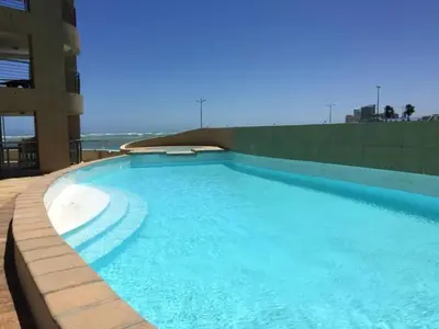 a large swimming pool on top of a building at Luxury 3BR - 804 Ocean View Pool & Parking Beach Walks in Strand