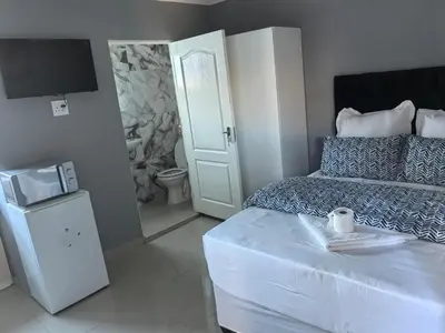 a small bedroom with a bed and a television at Gift Guest house 3 in Cravenby