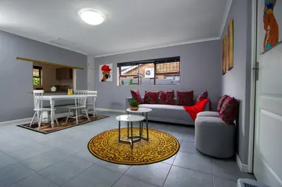 a living room with a couch and a table at Winelands Escape in Durbanville