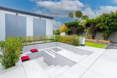 a white patio with red pillows sitting on it at Winelands Escape in Durbanville