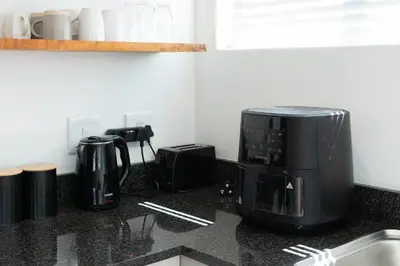 a kitchen counter with a microwave and a coffee maker at Apartment Paradys - Serviced in Stellenbosch