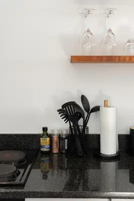 a kitchen counter with utensils on a counter top at Apartment Paradys - Serviced in Stellenbosch