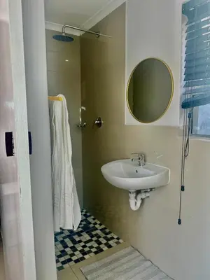 a bathroom with a sink and a mirror at Hideaway Haven in Cape Town