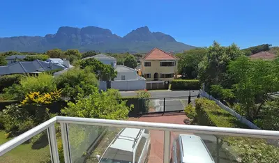 a balcony with a view of a house at Cape Town Studio Apartment in Cape Town