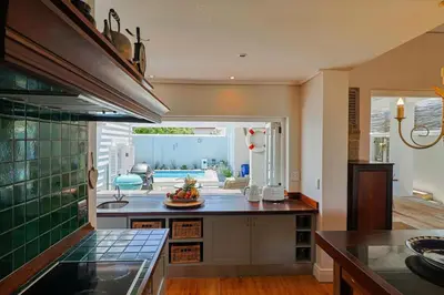 a kitchen with a sink and a counter top at Nautilus on Grotto Beach - heated pool in Hermanus