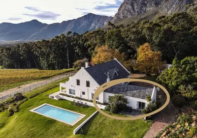 an aerial view of a white house with a swimming pool at Wildeberg Elephants Trail Cottage in Franschhoek