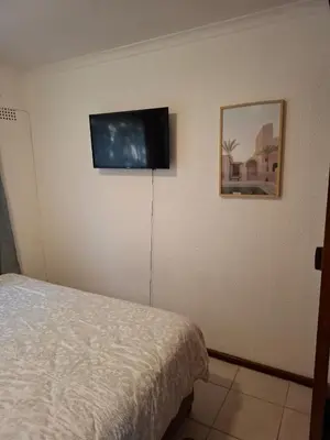 a bedroom with a bed and a flat screen tv on the wall at Chez Yves 2 in Hoheizen