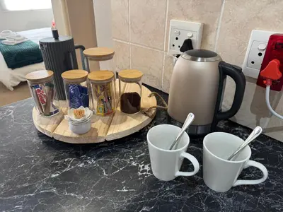 a counter top with two cups and a coffee maker at Melk Tert - Paarl - Self Catering Apartment in Paarl