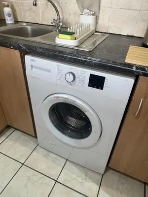 a washing machine in a kitchen next to a sink at Melk Tert - Paarl - Self Catering Apartment in Paarl