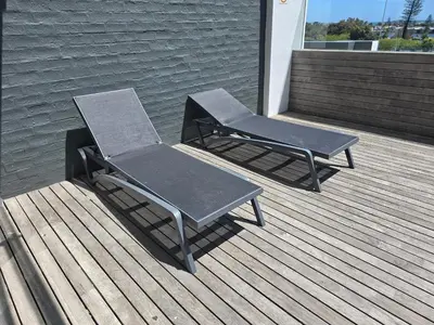 two chairs and a table on a deck at Sunset at Keys in Cape Town