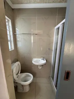 a bathroom with a toilet and a sink at Our Home Guest House in Bellville
