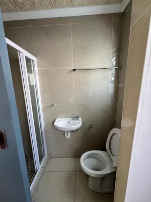 a bathroom with a toilet and a sink at Our Home Guest House in Bellville