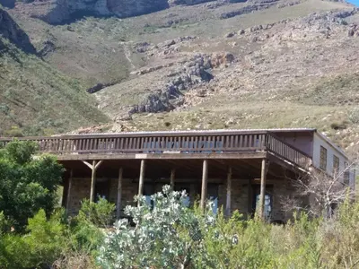 a building with a deck on the side of a mountain at Avondrood Mountain House in Rawsonville