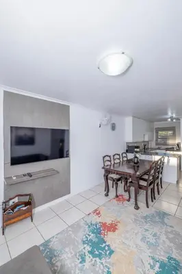 a living room with a table and a tv at Prime Apartments in Richwood