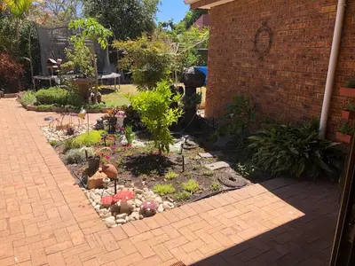 a garden with flowers and plants in a yard at Charming Self-Catering Apartment in Tygerberg Hills