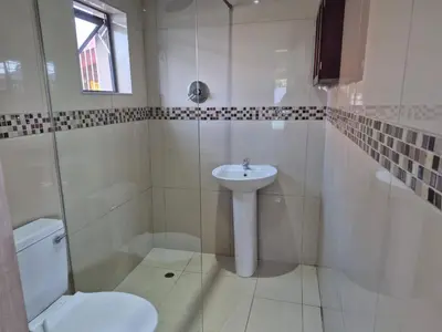 a white bathroom with a sink and a toilet at Maglovir Economy in Tiervlei