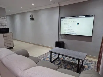 a living room with a couch and a projection screen at Maglovir Economy in Tiervlei
