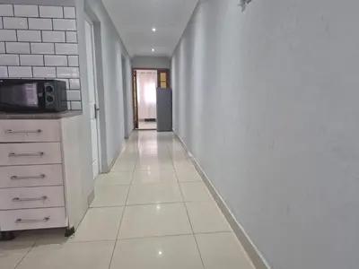an empty hallway with a kitchen and a microwave at Maglovir Economy in Tiervlei