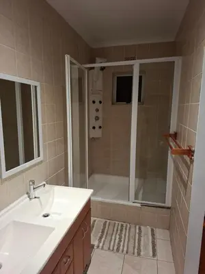 a bathroom with a tub and a sink and a shower at Leigh's home with dogs in Cape Town
