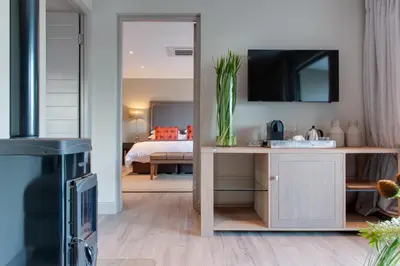 a living room with a bedroom with a bed at The Jordan Suites in Stellenbosch
