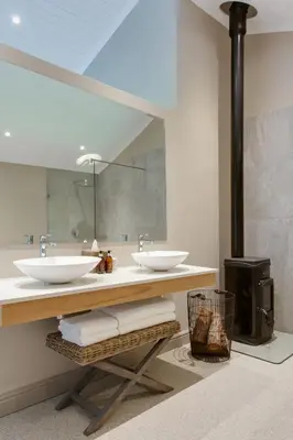 a bathroom with two sinks and a mirror at The Jordan Suites in Stellenbosch