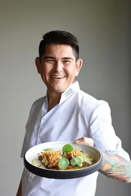 a man is holding a plate of food at The Jordan Suites in Stellenbosch