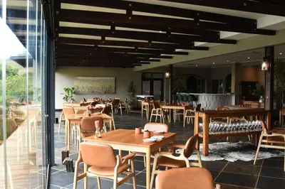 a restaurant with tables and chairs in a room at The Jordan Suites in Stellenbosch