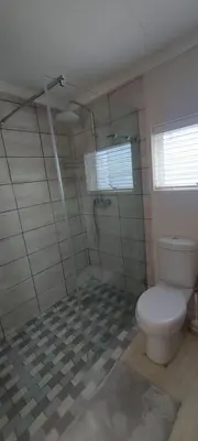 a bathroom with a toilet and a shower at Amanda's Place in Hermanus