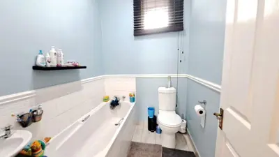 a bathroom with a tub and a toilet and a sink at Self catering accommodation in Cape Town
