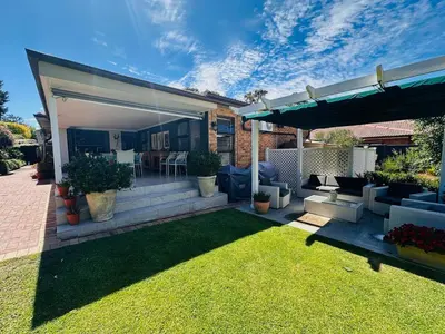 a house with a patio with a grass yard at Lelani Self Catering Cape Town in Oakdale