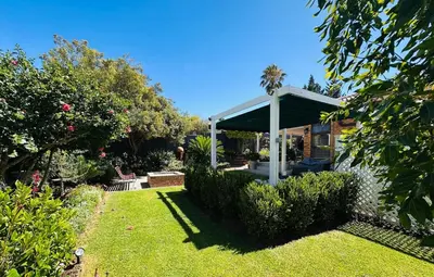 a garden with a gazebo in a yard at Lelani Self Catering Cape Town in Oakdale