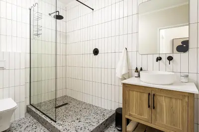 a bathroom with a sink and a shower at Canal Front Apartment Cape Town in Cape Town