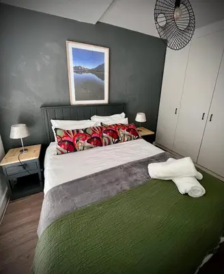 a bedroom with a large bed with two night stands at Splendour on Dorp in Stellenbosch
