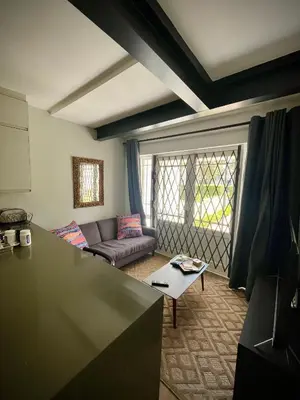 a living room with a couch and a table at Splendour on Dorp in Stellenbosch
